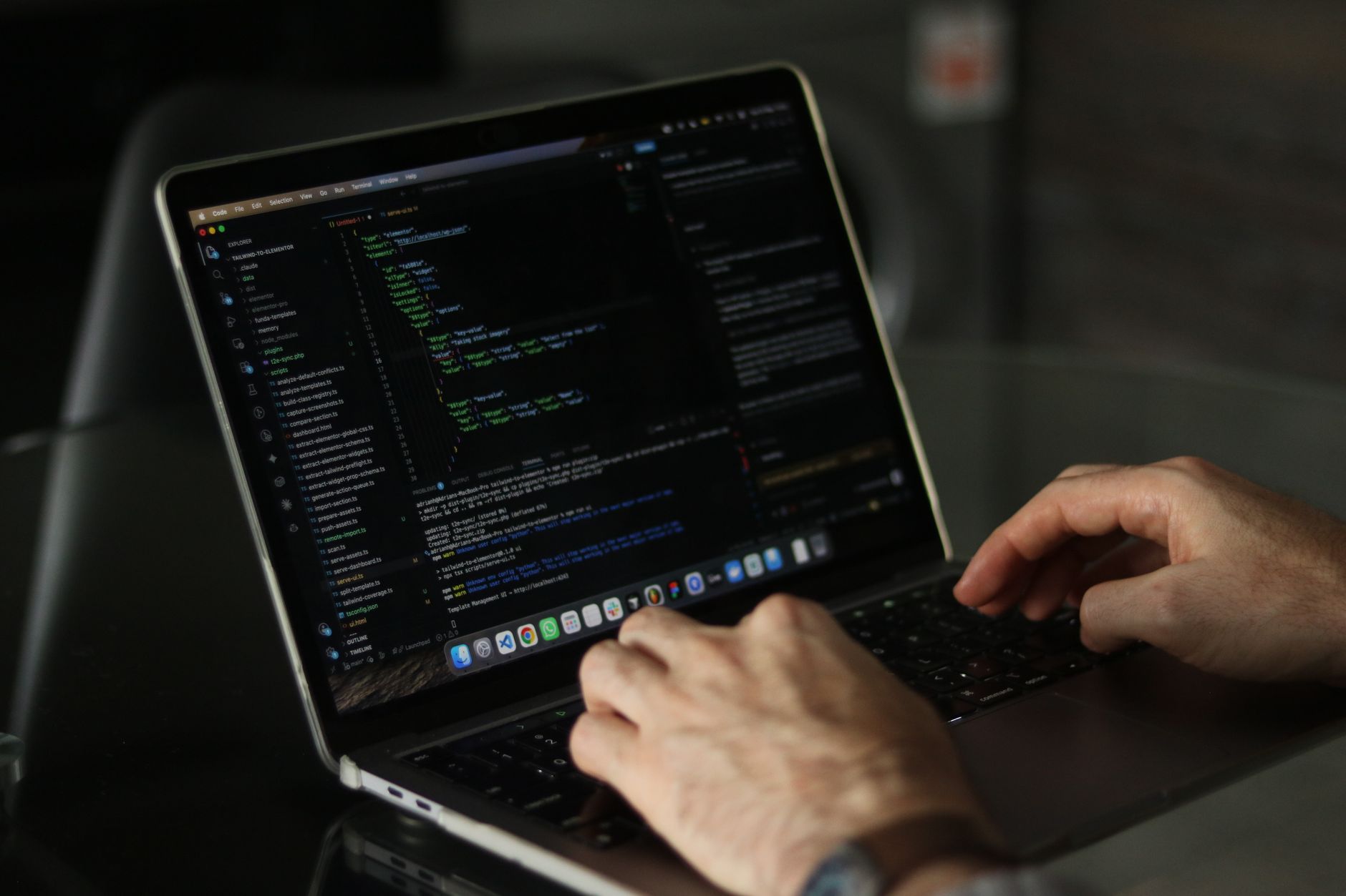Developer working on laptop with code, illustrating API integration and automation